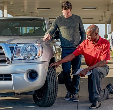 Service technician putting on a new Toyota tire.